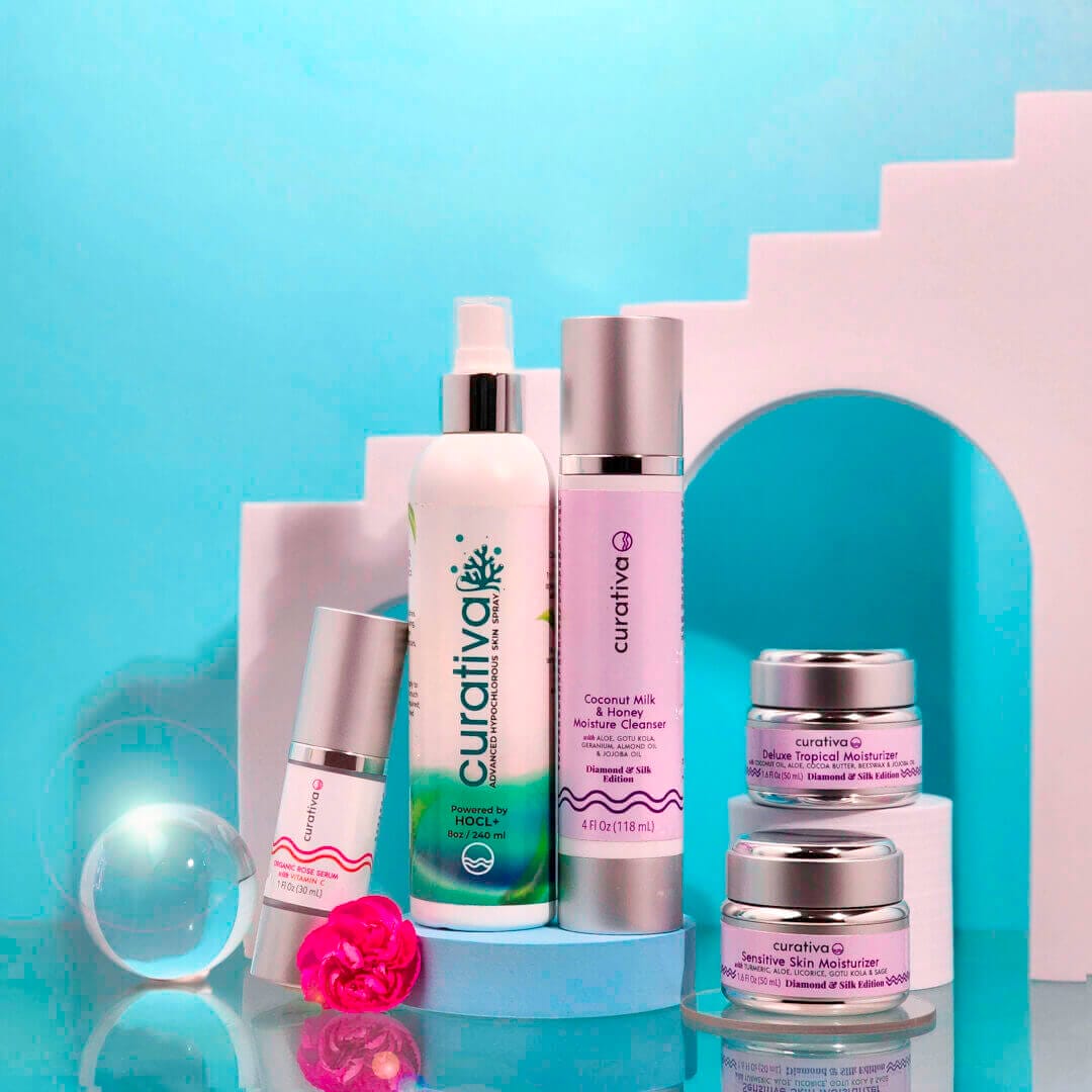 Luxury skincare products with pink and white bottles on turquoise background, featuring Curativa Bay Diamond & Silk collection.